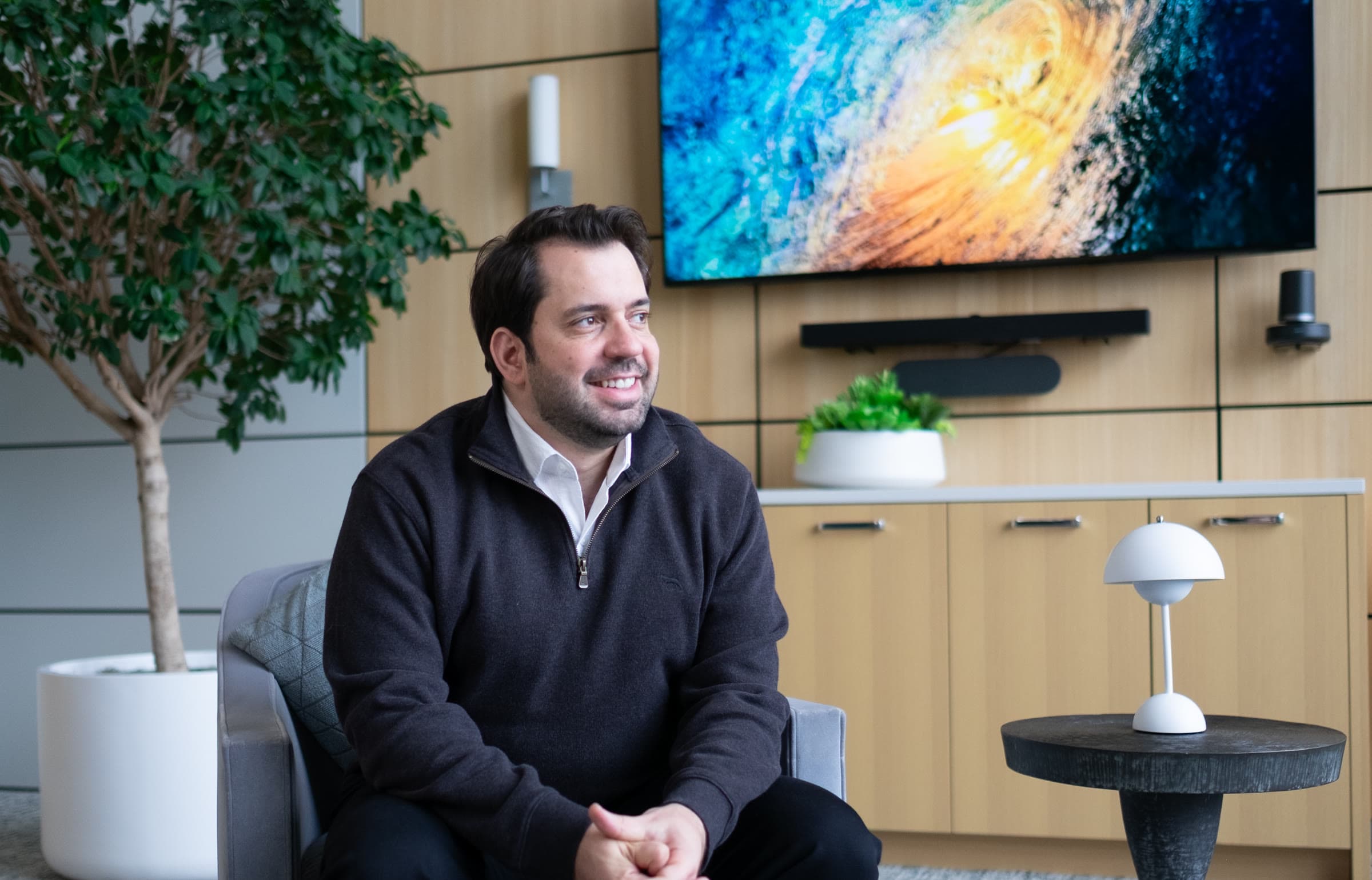 Dr. Rohi Atassi in the lounge, the wave painting behind him