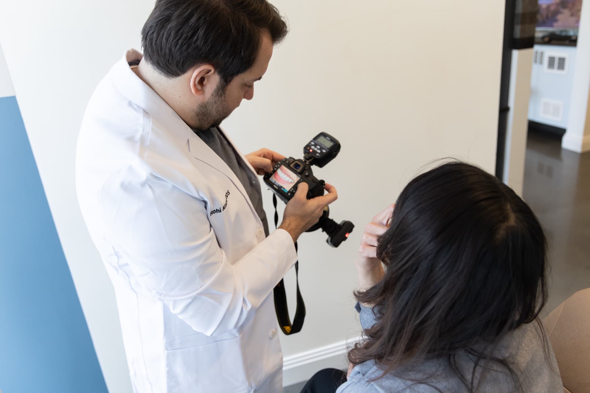 Dr. Atassi photographing a patient's teeth