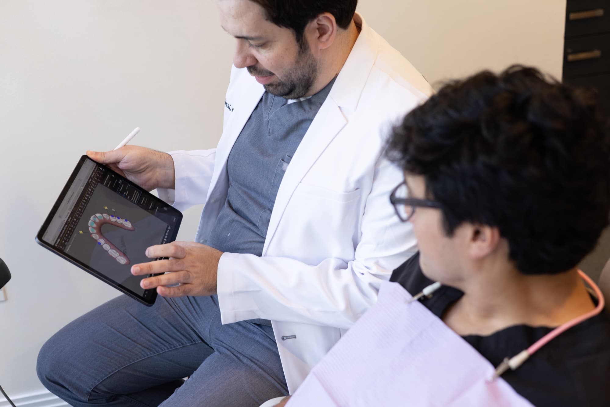 Dr. Atassi showing a patient a digital plan on a tablet